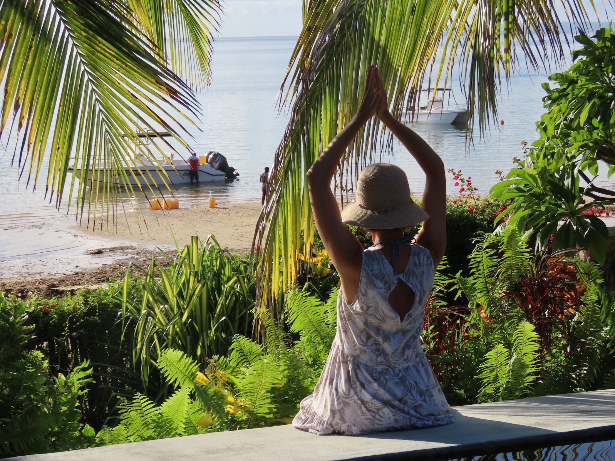 Nina pausing beside tropical water